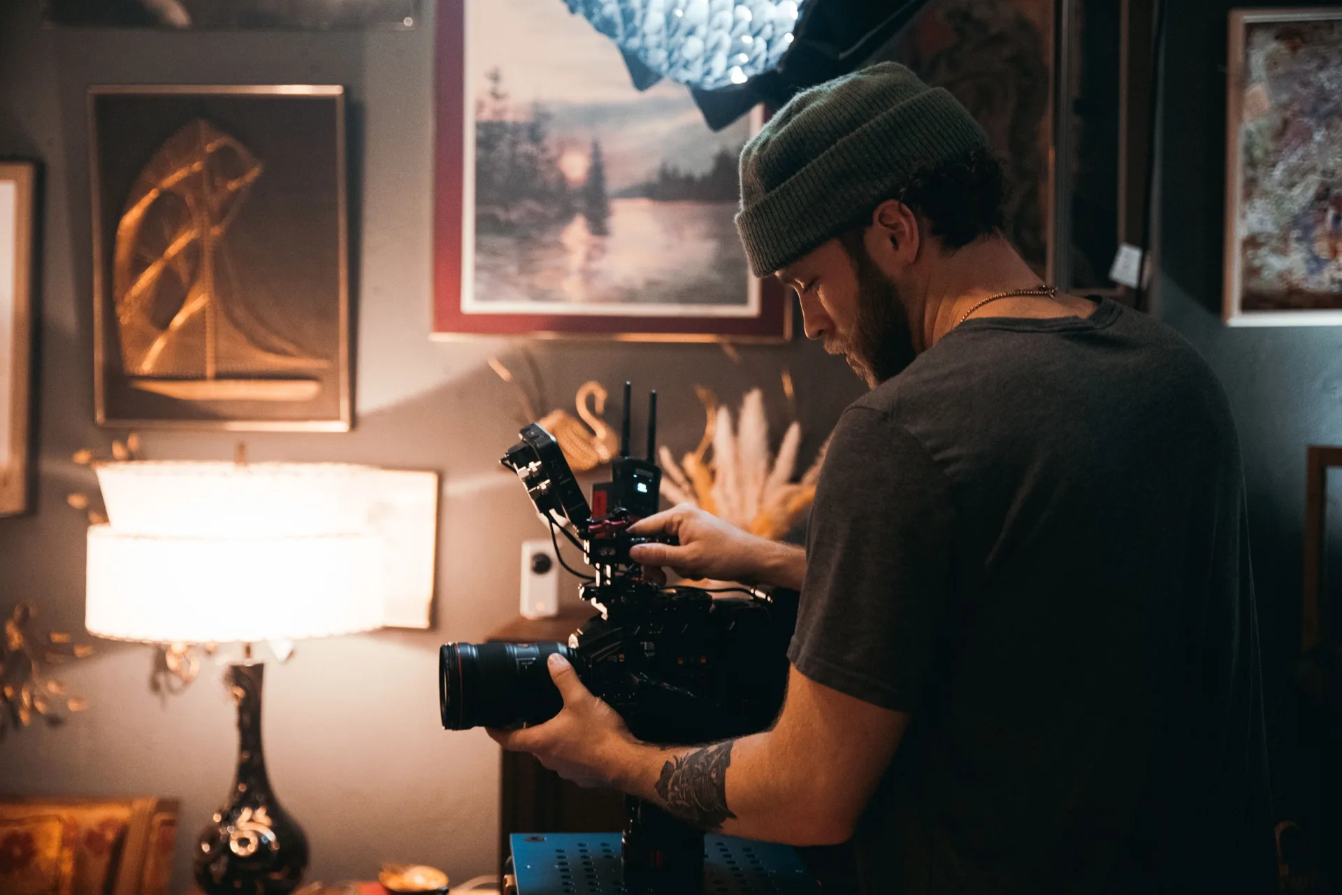 Videographer adjusting a professional cinema camera with external monitor