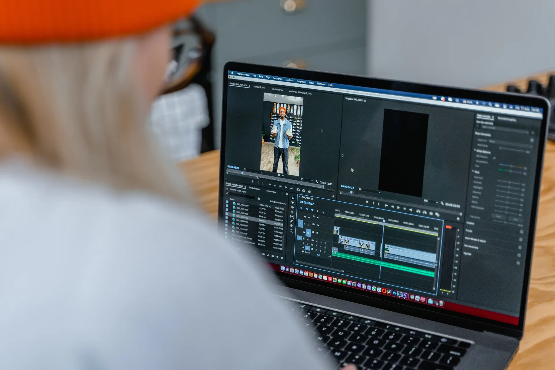 Video editor reviewing footage on a laptop in Adobe Premiere Pro to pick a thumbnail frame