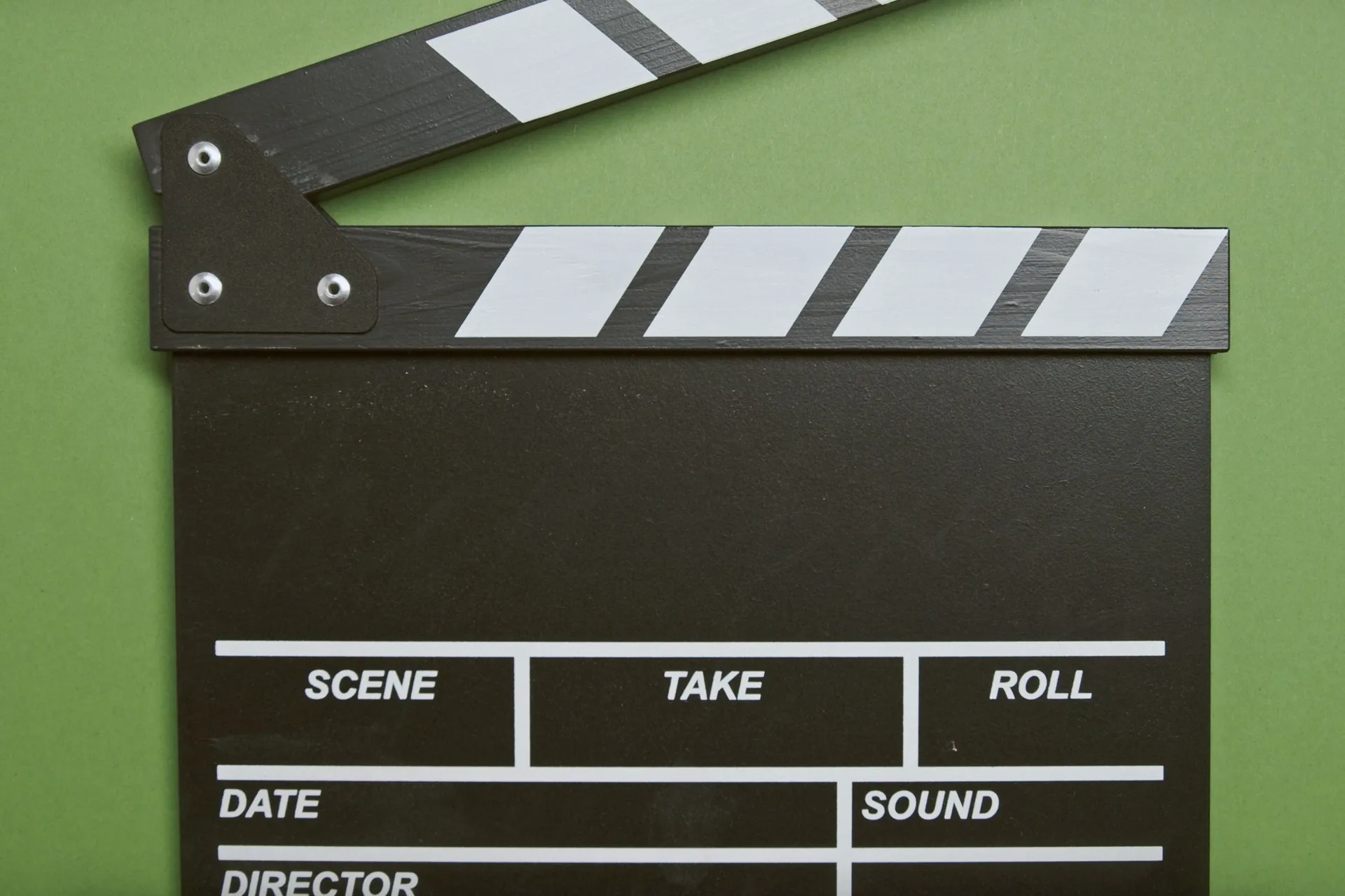 Movie clapperboard on a green background, symbolizing video production and frame capture